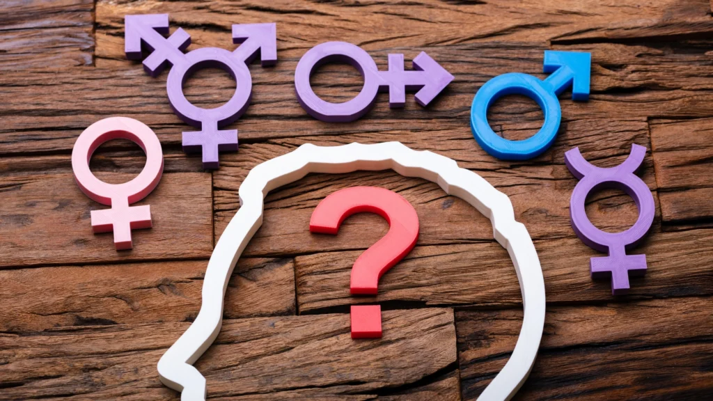Symbols-of-different-genders-encircle-a-silhouette-of-a-head-with-a-question-mark-reflecting-exploration-and-understanding-of-gender-norms