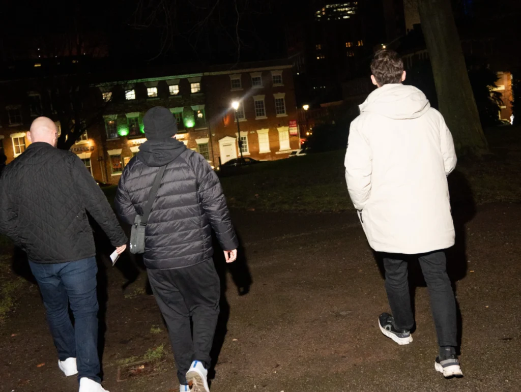 Three-people-walk-through-a-park-at-night-during-an-MPC-event-part-of-Season-2-Session-3-Relationships