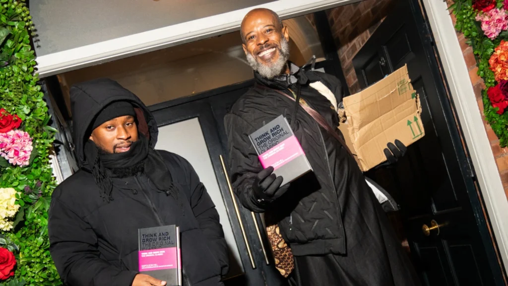 Two-individuals-holding-Think-and-Grow-Rich-at-an-MPC-emotional-wellness-relationship-event-in-Birmingham