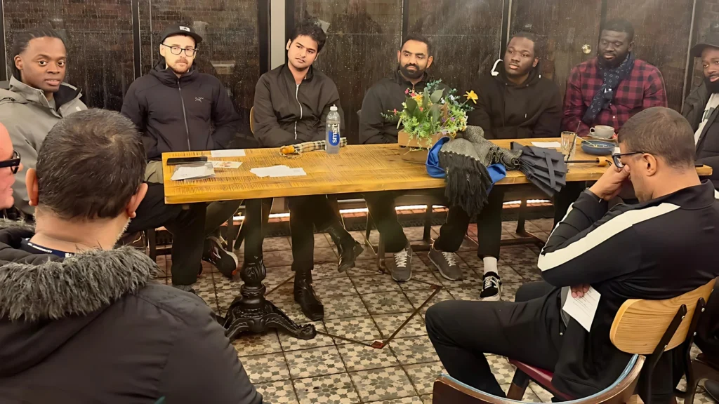MPC-group-sitting-around-a-table-in-a-cozy-indoor-setting-engaged-in-discussion