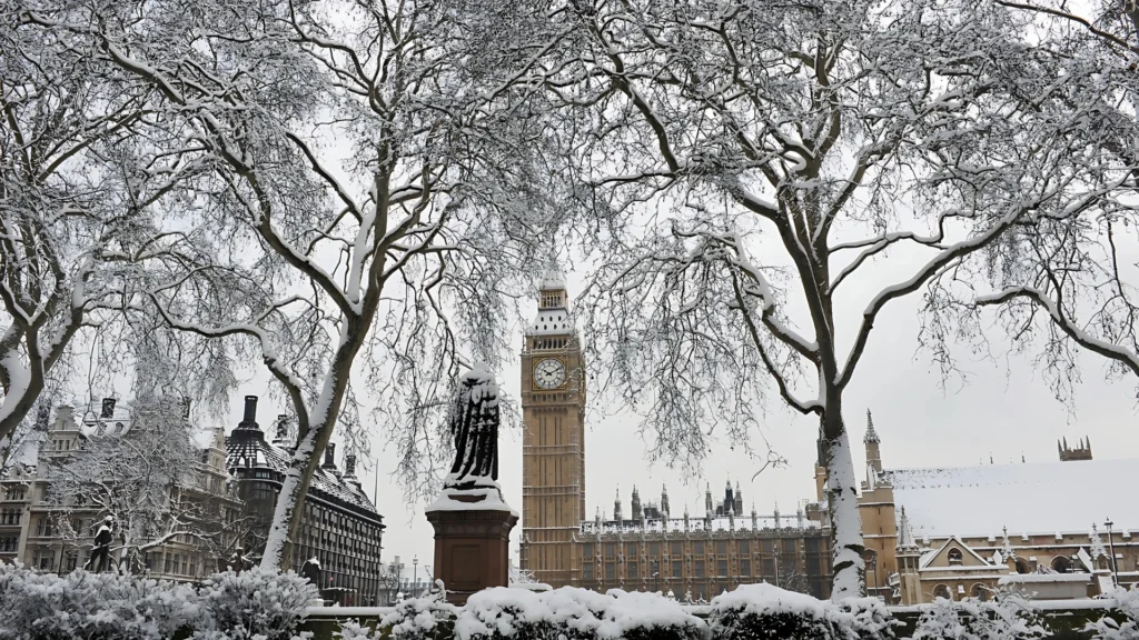 a-snow-covered-scene-in-London-with-Big-Ben-in-the-background-framed-by-snow-laden-trees-creating-a-serene-and-wintery-atmosphere
