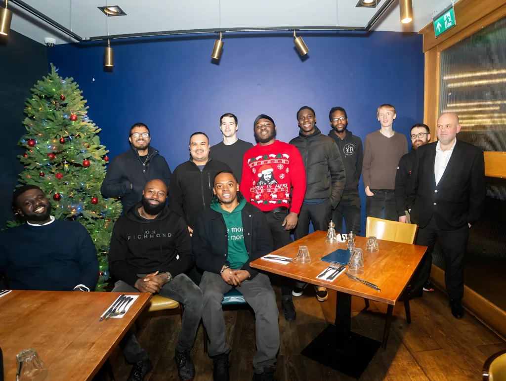 MPC-finance-event-group-photo-in-front-of-Christmas-tree.