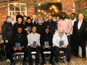 MPC-relationship-event-group-photo-with-participants-holding-notebooks