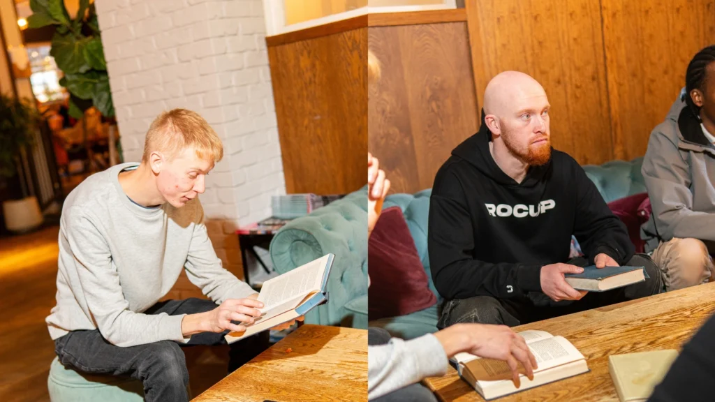 Two-members-of-the-Mens-Prosperity-Club-(MPC)-engaged-in-reading-books-in-a-group-setting-promoting-spiritual-growth-and-personal-development-through-reflection-and-shared-learning