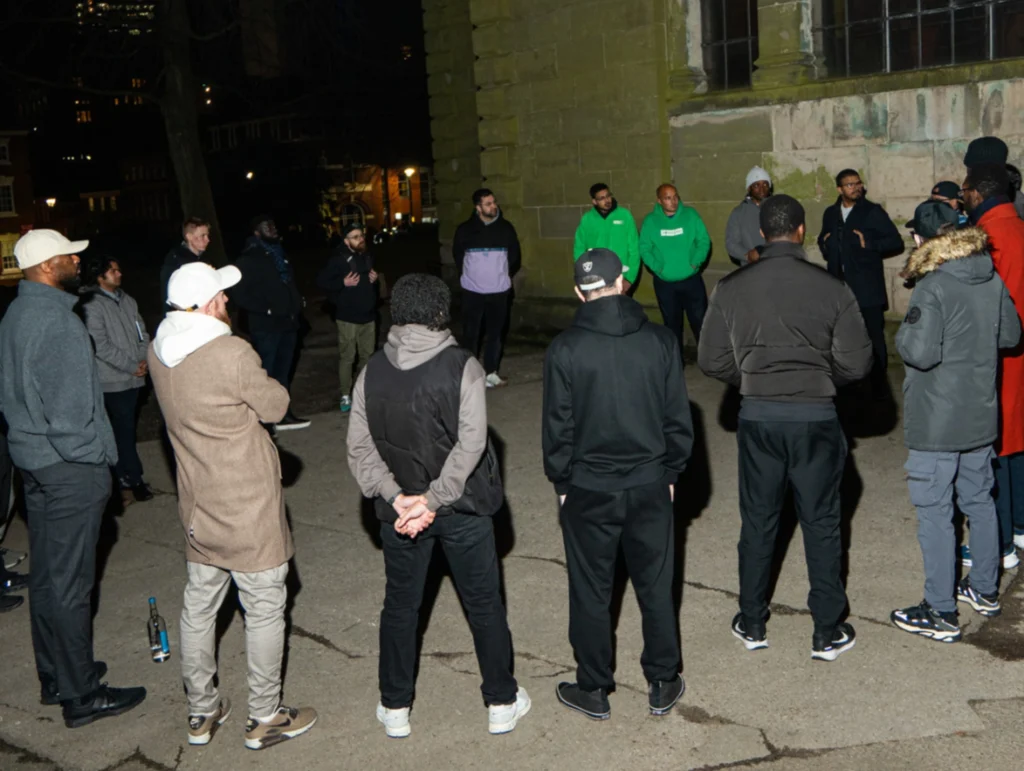A-group-of-people-gathered-outdoors-for-a-discussion-possibly-during-season-2-session-4-of-MPC