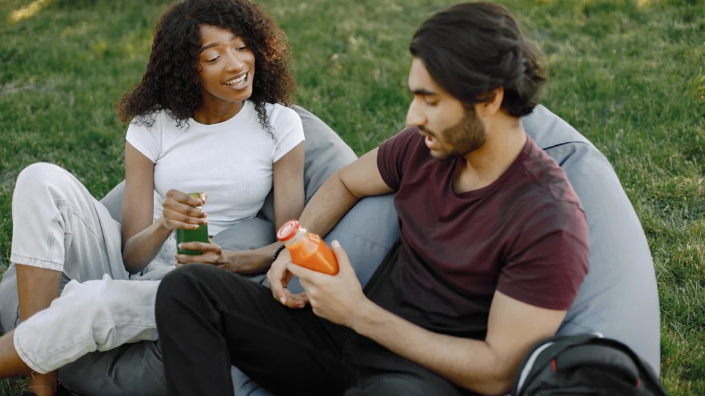 A-couple-shares-a-relaxed-conversation-outdoors-symbolizing-the-sexual-link-between-healthy-relationships-and-mental-well-being