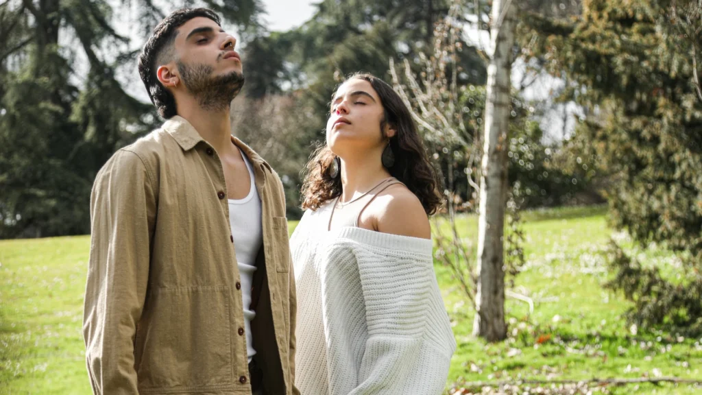 Young-Man-and-a-Girl-Doing-Deep-Breathing-meditation-in-the-Park