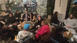 Group-of-people-engaging-in-discussion-at-a-MPC-event-in-a-cozy-venue-with-food-and-drinks-enjoyed-together