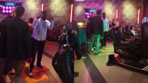 Guests-socialising-and-playing-racing-simulators-at-an-MPC-events-Social-Game-night-in-a-neon-lit-arcade-venue