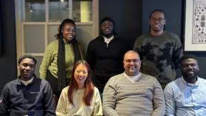 MPC-committee-members-smiling-together-in-a-group-photo-in-a-modern-indoor-setting