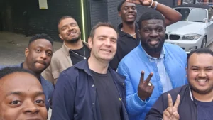 MPC-members-smiling-and-posing-outdoors-in-a-casual-group-selfie-with-a-car-in-the-background
