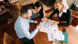 People-discussing-financial-documents-Collaborating-on-financial-planning-a-key-aspect-of-money-mindset-for-men-in-their-20s