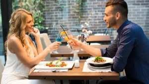 A-couple-enjoying-a-romantic-dinner-embodying-the-777-rule-for-relationship-growth
