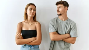 A-couple-standing-with-arms-crossed-showing-a-moment-of-tension-which-could-represent-the-need-for-resolving-conflicts