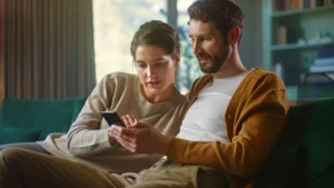Couple-looking-at-a-phone-together-engaging-with-the-content