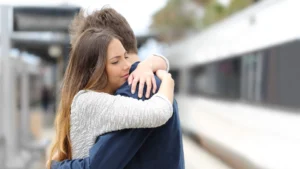 Image-showing-a-couple-embracing-with-a-somber-tone-depicting-a-farewell