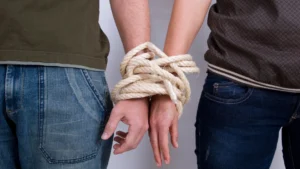 Two-hands-bound-by-rope-symbolizing-emotional-dependency-and-the-struggle-to-break-free.