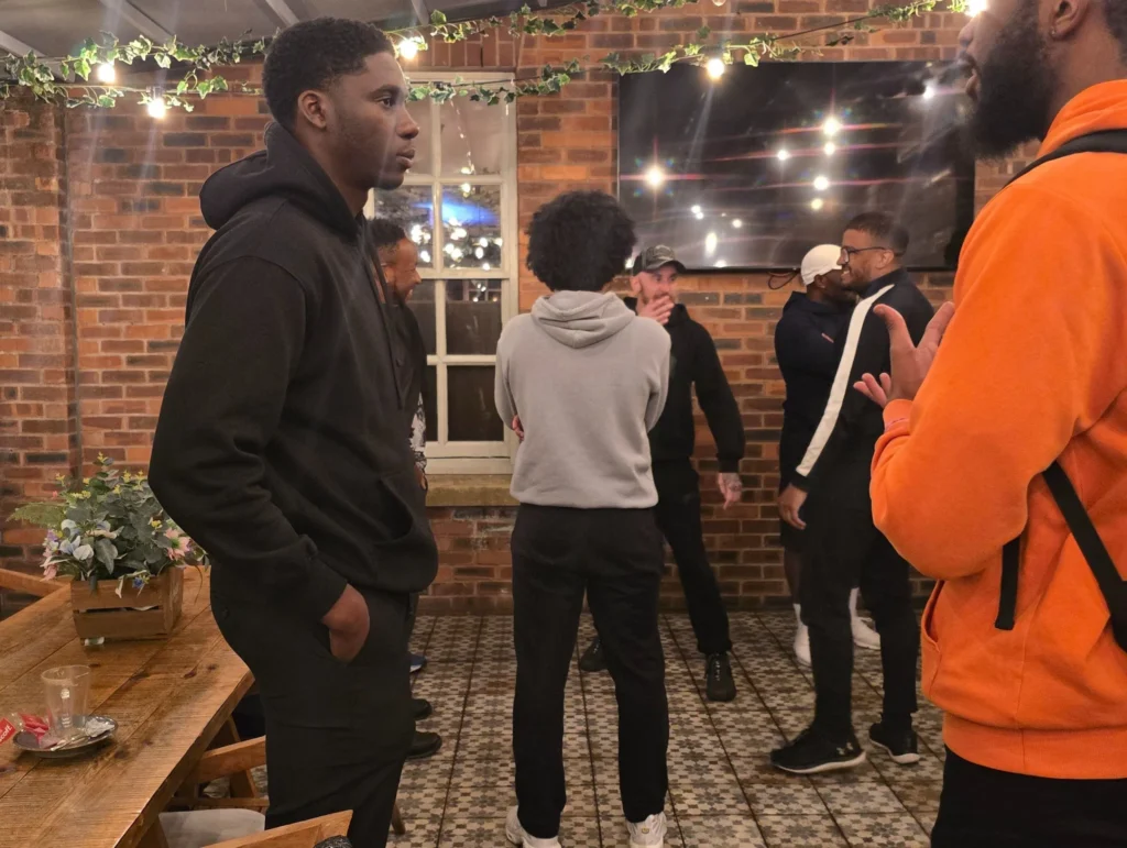 A-group-of-people-at-a-networking-event-with-some-talking-and-others-standing-quietly-in-the-background