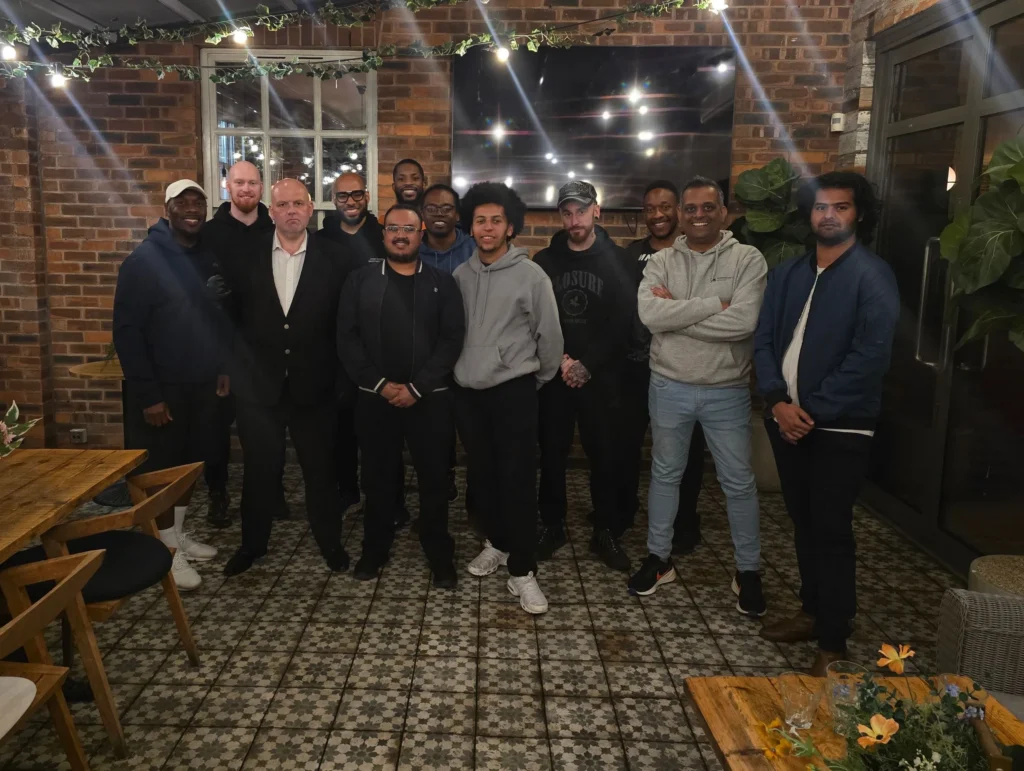 A-group-photo-of-attendees-at-a-networking-event-all-smiling-and-posing-together-in-a-casual-setting