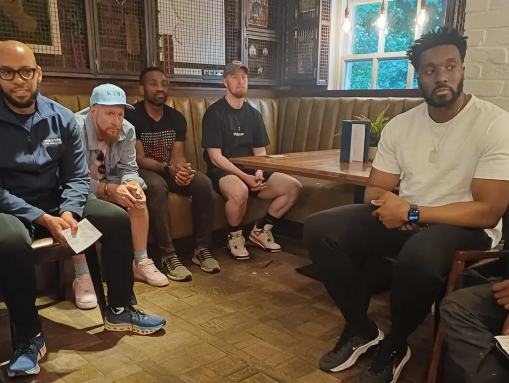 Another-shot-of-participants-at-the-Mens-Prosperity-Club-event-seated-and-having-a-group-conversation