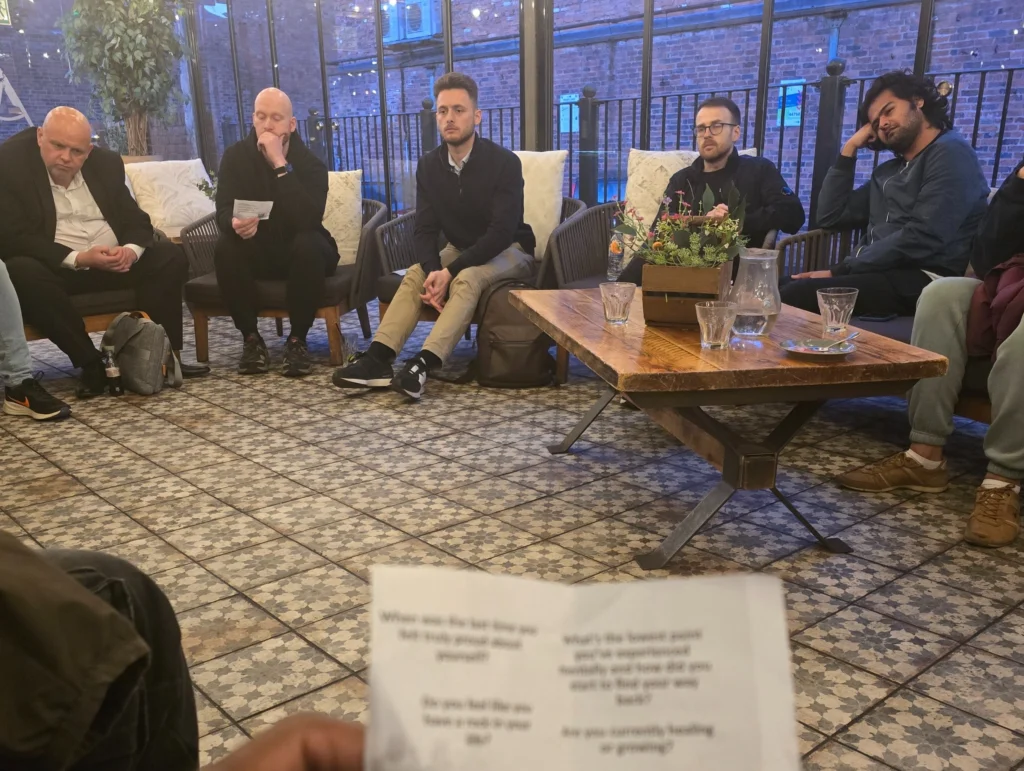 Group-of-people-sitting-in-a-cozy-setting-at-the-MPC-event-discussing-relationship-focused-questions