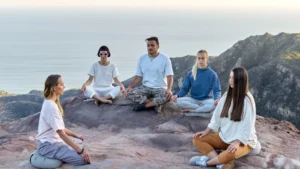 Spiritual-Healing-meditation-outdoors-Image-of-a-group-of-people-meditating-on-a-mountaintop-with-a-peaceful-natural-backdrop