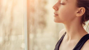 Young-woman-using-Meditation-Techniques-to-relax-indoors