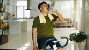 Person-sipping-water-after-cycling-emphasizing-the-importance-of-hydration-during-fitness