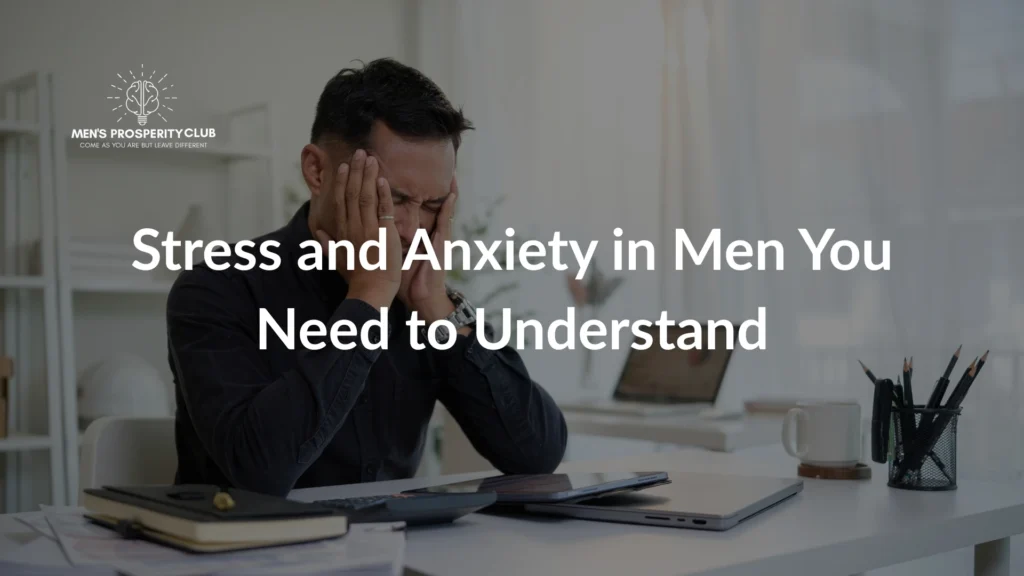 A-man-holding-his-head-in-stress-sitting-at-a-desk-surrounded-by-paperwork-and-a-laptop-symbolizing-stress-and-anxiety