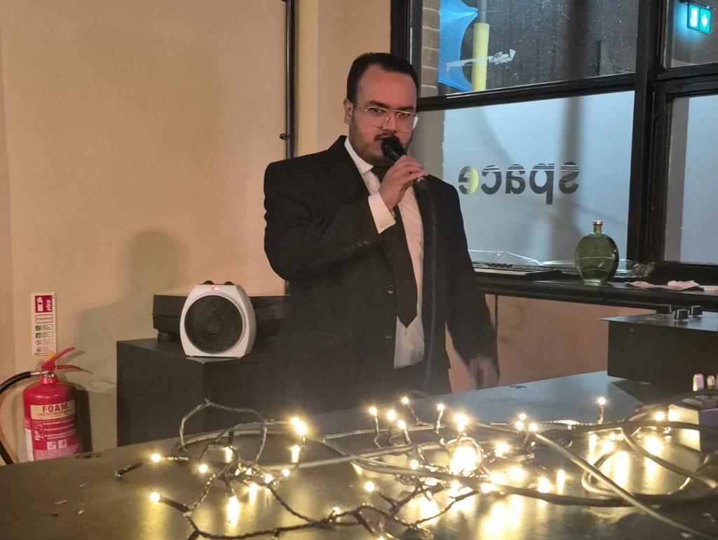 A-host-performing-at-a-social-event-Games-Social-October-2025