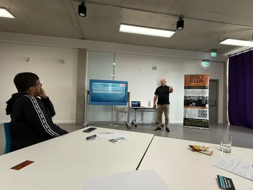 John-Kenny-presenting-at-a-PD-workshop-with-the-audience-listening-intently-and-taking-notes