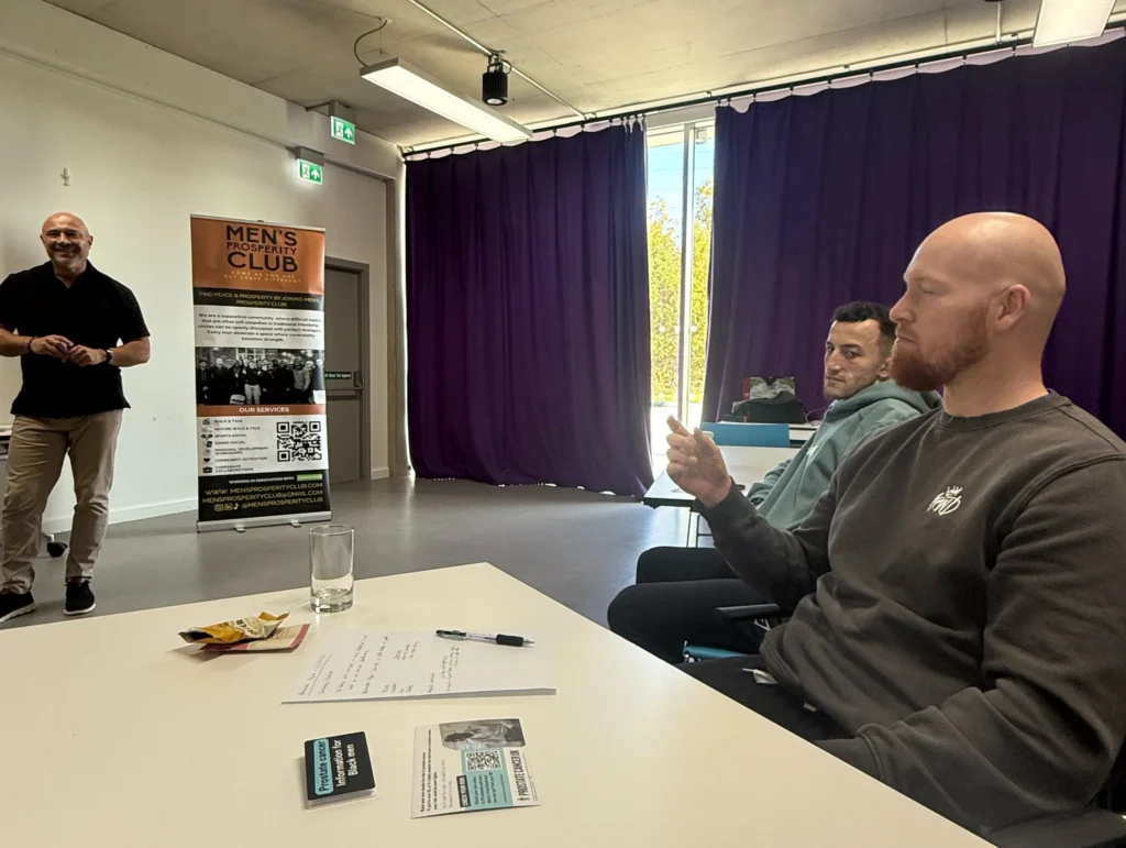 John-Kenny-presenting-at-the-PD-workshop-with-attendees-engaged-and-taking-notes-while-a-break-snack-is-on-the-table