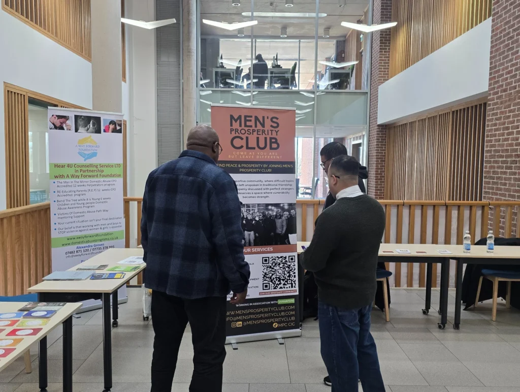 Newman-University-Event-Interaction-between-Men's-Prosperity-Club-representative-and-a-visitor