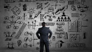 Business-leader-planning-strategy-with-drawings-of-leadership-and-teamwork