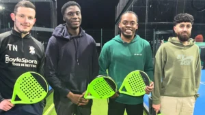 A-group-of-friends-holding-pickleball-paddles-smiling-and-ready-for-action-in-Birmingham