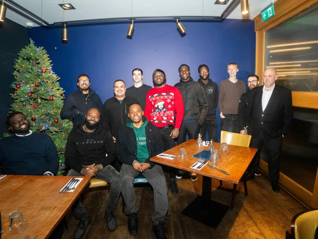 Group-photo-at-a-restaurant-during-a-celebration-discussing-relations-topics
