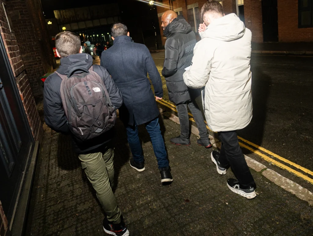 Group-walking-side-by-side-down-a-city-street-during-the-night-reflecting-on-relations-topics