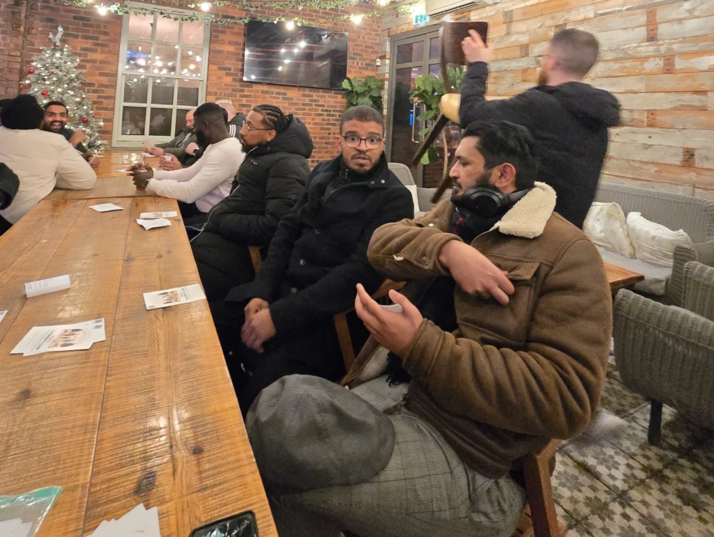 Men-gathered-at-the-Men’s-Prosperity-Club-event-engaging-in-conversations-to-improve-mental-health-and-personal-growth