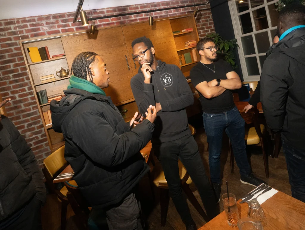 People-engaged-in-a-conversation-about-finance-topics-at-restaurant