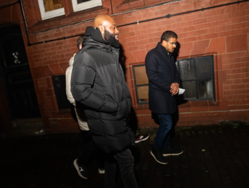 People-walking-together-at-night-discussing-relations-topics-along-the-sidewalk