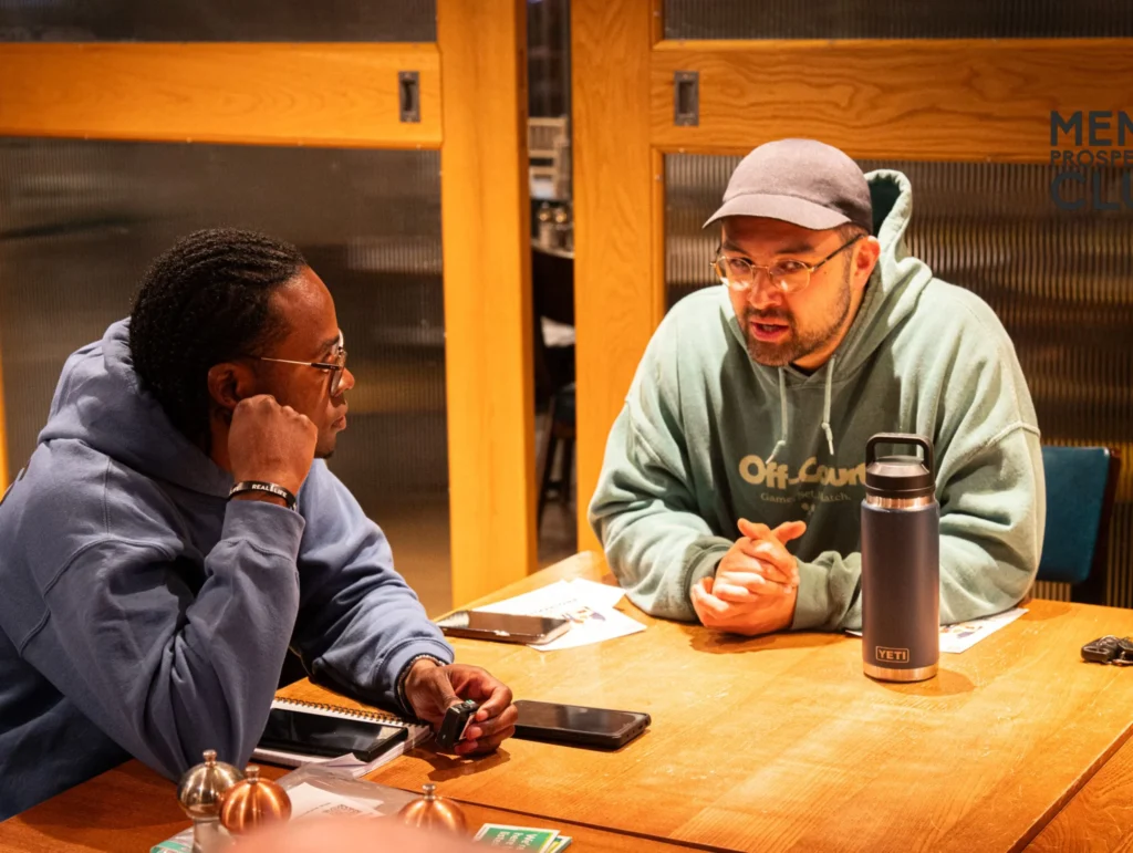 Team-enjoying-conversation-about-health-and-fitness-at-dinner